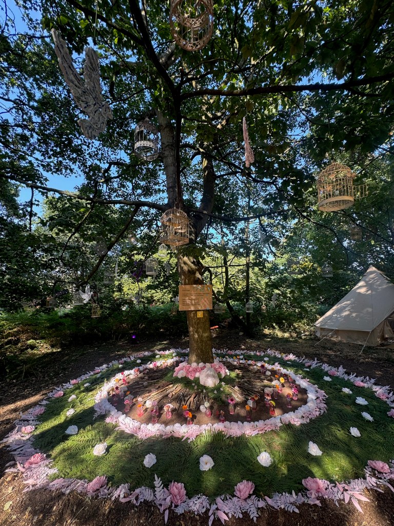 an image of the peace garden at latitude festival 2026, a pink rose quartz mandala with doves above